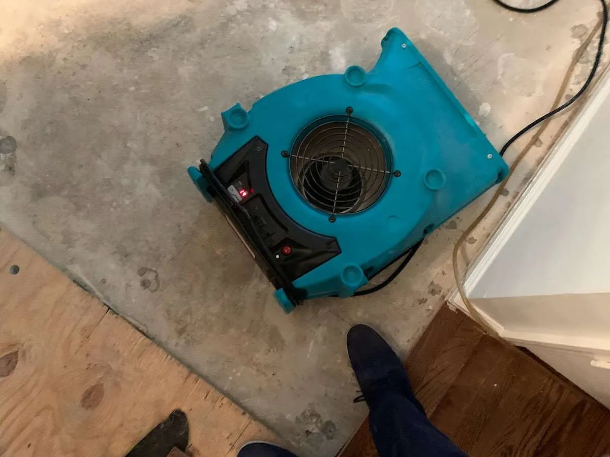 Air mover drying subfloor during Commercial Water Damage Restoration in Wade Hampton